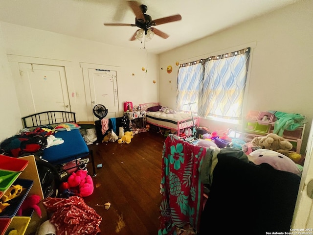 bedroom featuring wood finished floors and a ceiling fan