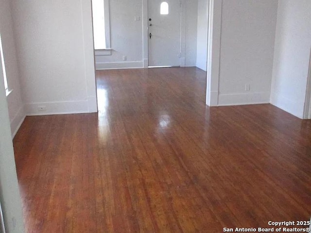 unfurnished room with wood finished floors