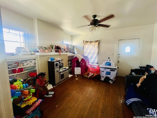 rec room with ceiling fan and wood finished floors