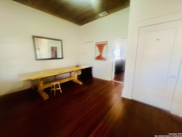 dining room featuring visible vents and dark wood-style flooring