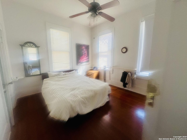 bedroom with a ceiling fan and wood finished floors