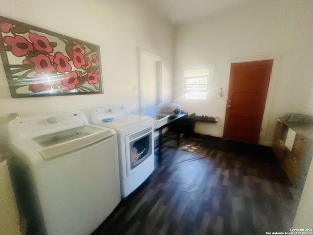 clothes washing area featuring washer and dryer, dark wood-style flooring, and laundry area