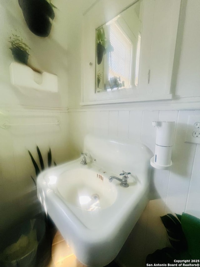 bathroom with tile walls and wainscoting