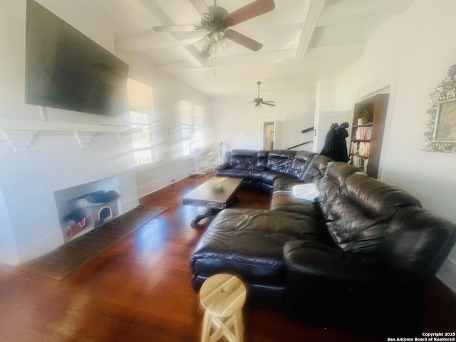 living area featuring baseboards, ceiling fan, beam ceiling, wood finished floors, and coffered ceiling