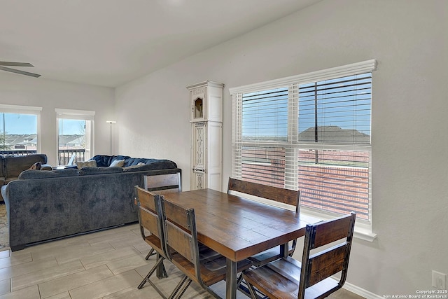 dining area featuring a ceiling fan and baseboards