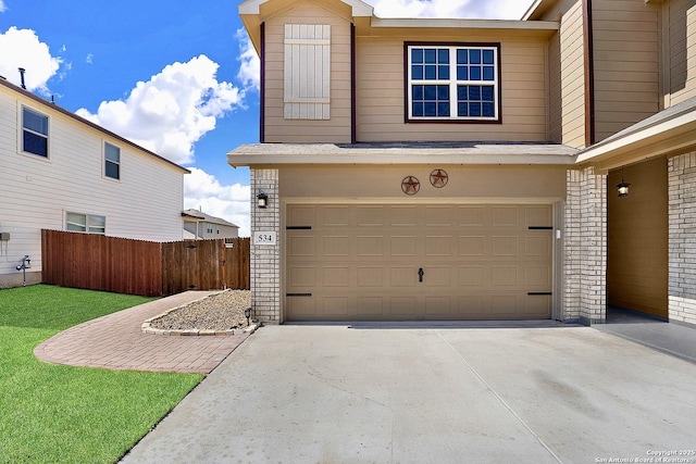 garage featuring concrete driveway and fence