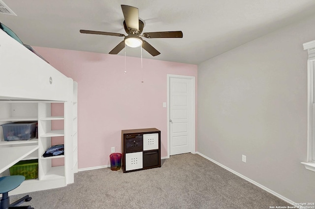 unfurnished office featuring visible vents, baseboards, ceiling fan, and carpet floors