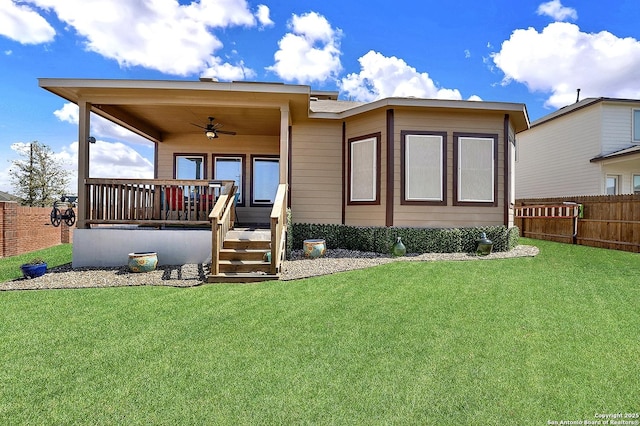 back of house featuring a yard, ceiling fan, and fence