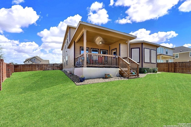 rear view of house featuring a lawn, a fenced backyard, and ceiling fan