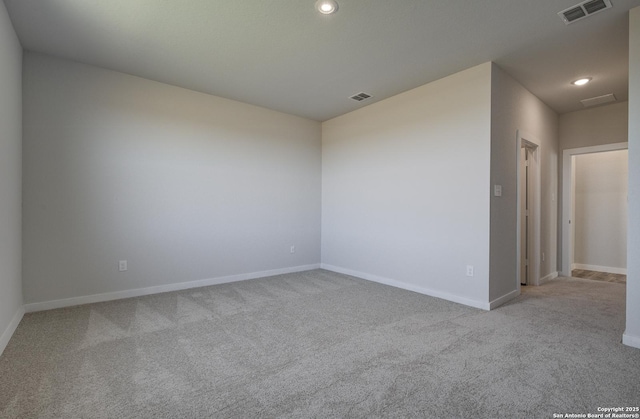 spare room with recessed lighting, visible vents, carpet flooring, and baseboards