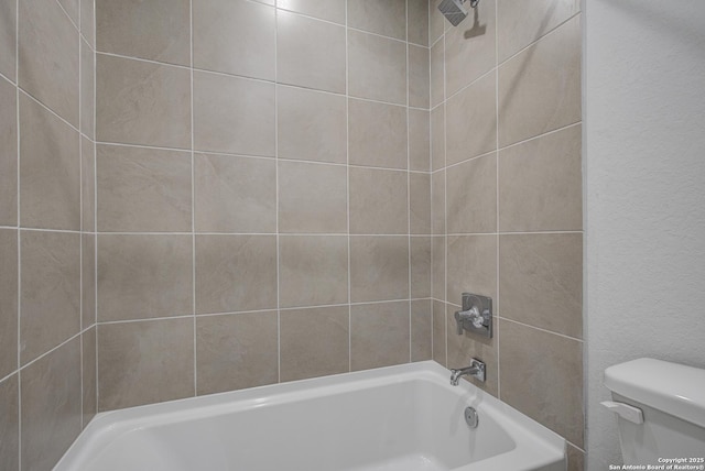 bathroom with toilet and bathtub / shower combination