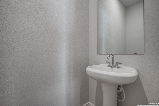 bathroom with a textured wall