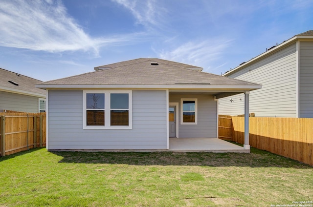 back of property with a yard, a patio, and a fenced backyard