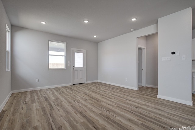 interior space with recessed lighting, light wood-type flooring, and baseboards