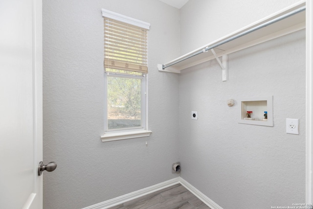 clothes washing area featuring electric dryer hookup, washer hookup, baseboards, gas dryer hookup, and laundry area