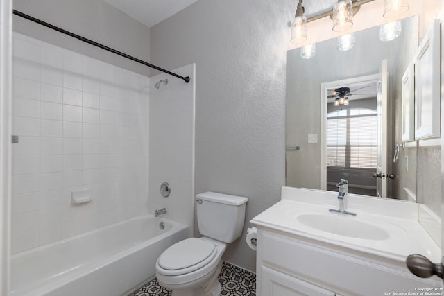 bathroom with vanity, a ceiling fan, toilet, a textured wall, and shower / bathtub combination