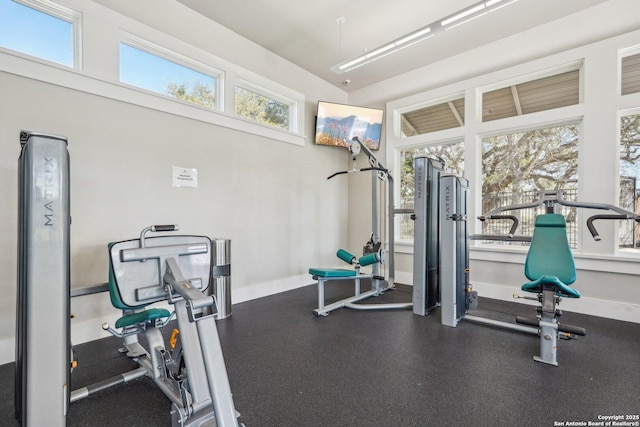 workout room featuring baseboards