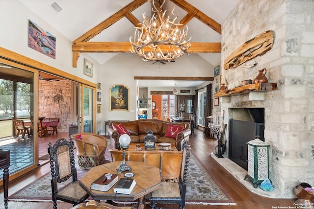 dining space featuring beamed ceiling, visible vents, high vaulted ceiling, wood finished floors, and a chandelier