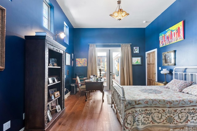 bedroom featuring french doors, wood finished floors, and access to outside