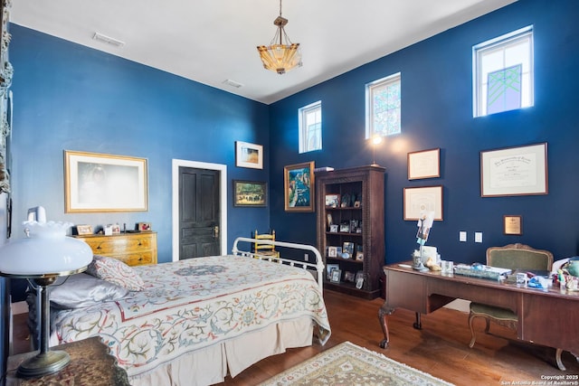 bedroom featuring visible vents and wood finished floors