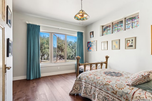 bedroom featuring baseboards and hardwood / wood-style floors