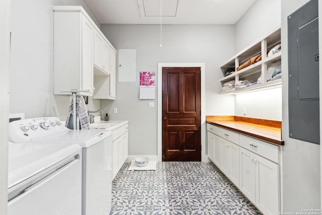 laundry room featuring light floors, attic access, electric panel, cabinet space, and independent washer and dryer