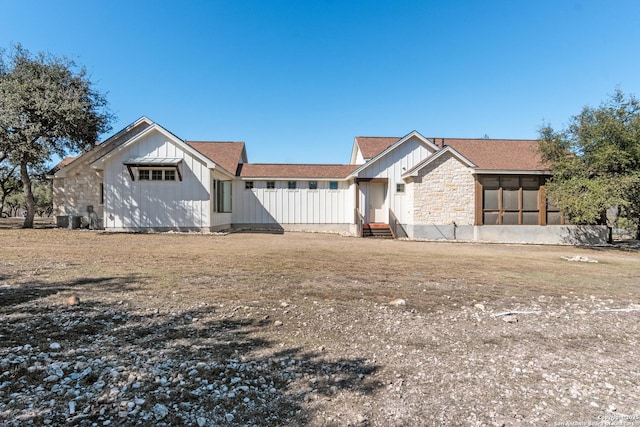 view of front of property featuring board and batten siding and a sunroom