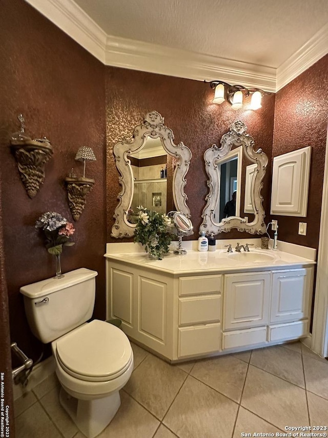 bathroom with vanity, crown molding, toilet, and tile patterned floors