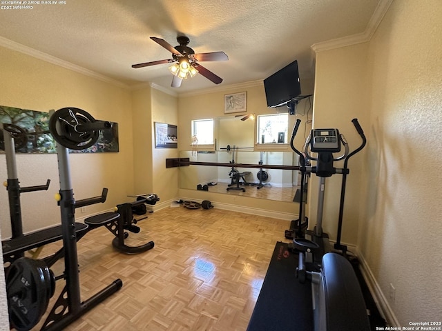 exercise area with ceiling fan, baseboards, a textured ceiling, and ornamental molding