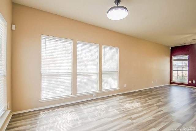 empty room featuring baseboards and wood finished floors