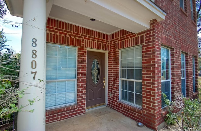 property entrance with brick siding