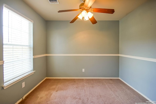 spare room with carpet flooring, a healthy amount of sunlight, and ceiling fan