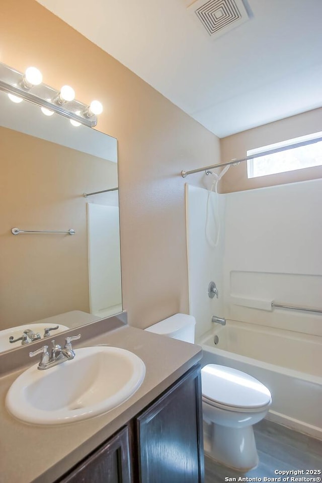 full bath featuring visible vents, toilet, vanity, and shower / tub combination