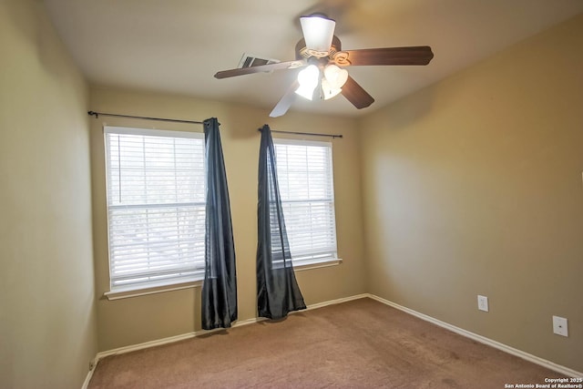 unfurnished room with carpet flooring, baseboards, and ceiling fan