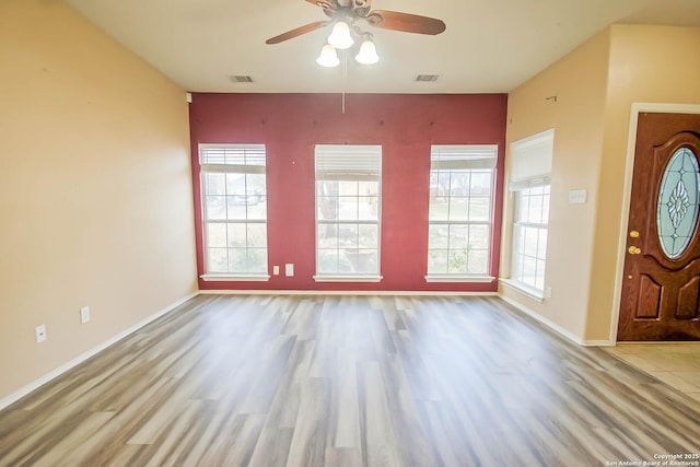 entryway featuring visible vents, plenty of natural light, a ceiling fan, and wood finished floors