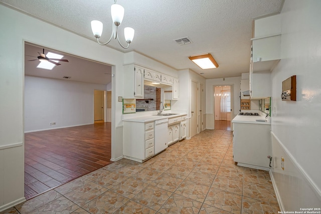 kitchen featuring a sink, light countertops, visible vents, and white dishwasher