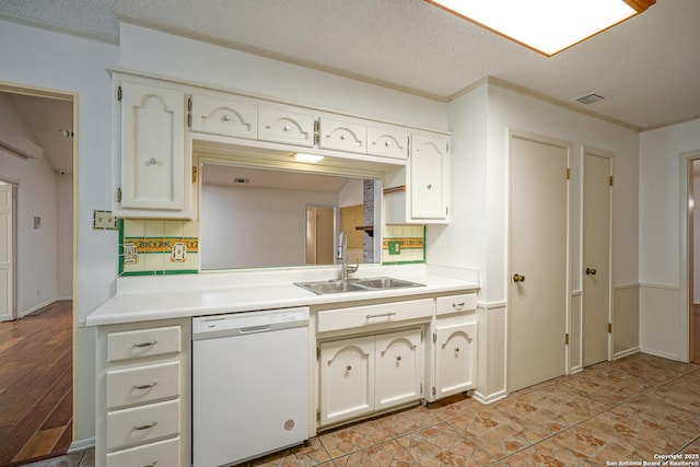 kitchen featuring a sink, crown molding, white dishwasher, and light countertops