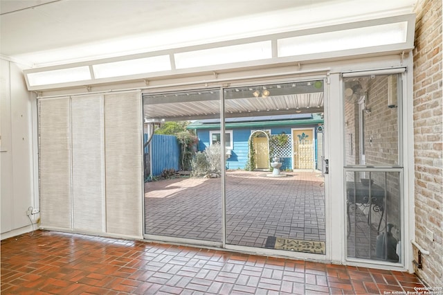 doorway to outside with brick floor and brick wall