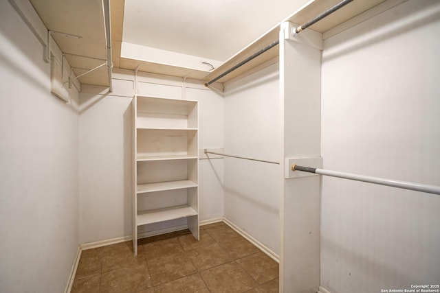 walk in closet with tile patterned floors