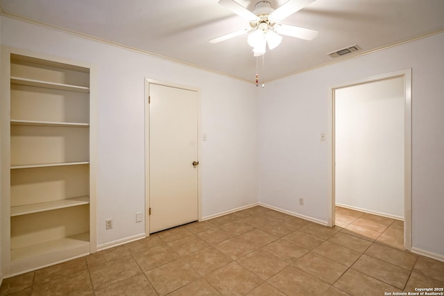 unfurnished bedroom featuring light tile patterned floors, visible vents, crown molding, and a ceiling fan