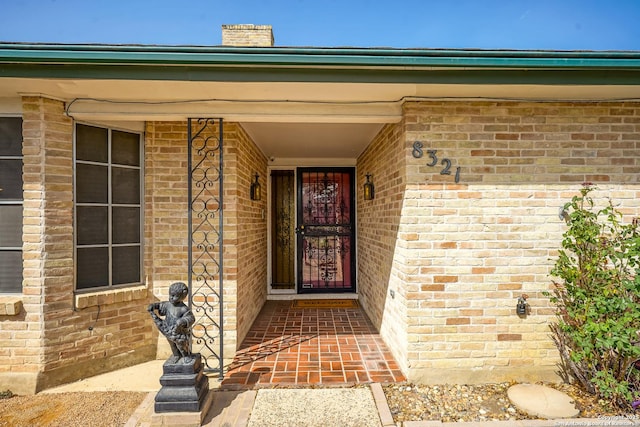 property entrance with brick siding