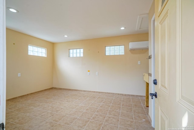 spare room featuring light tile patterned floors, baseboards, an AC wall unit, and recessed lighting