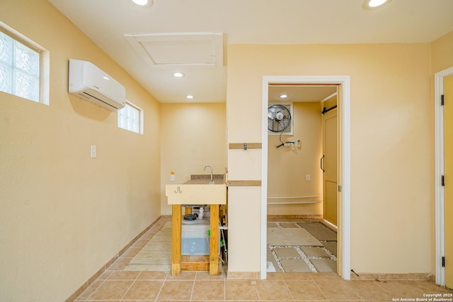 interior space featuring recessed lighting, an AC wall unit, and attic access