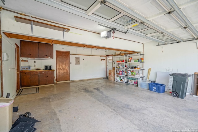 garage with electric panel and a garage door opener