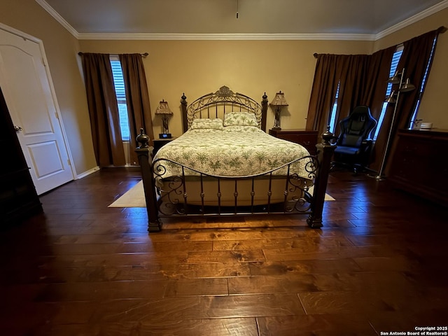 bedroom featuring baseboards, dark wood-style flooring, and ornamental molding