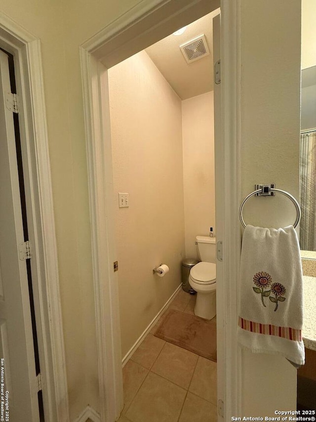 bathroom featuring tile patterned floors, toilet, baseboards, and visible vents