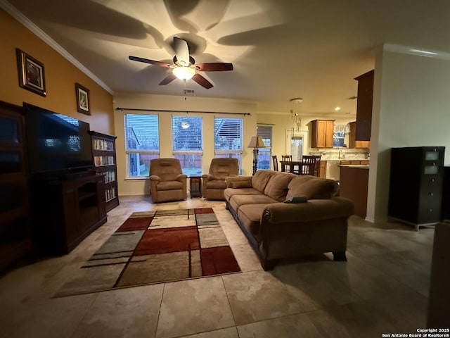 living room with a ceiling fan and crown molding