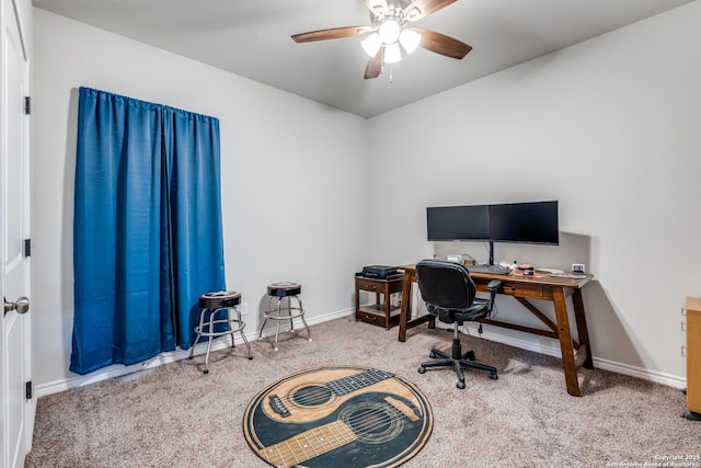 carpeted office space featuring baseboards and ceiling fan