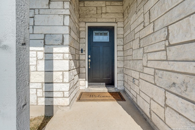 entrance to property featuring stone siding