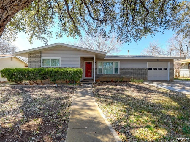 view of front facade featuring brick siding, an attached garage, and concrete driveway